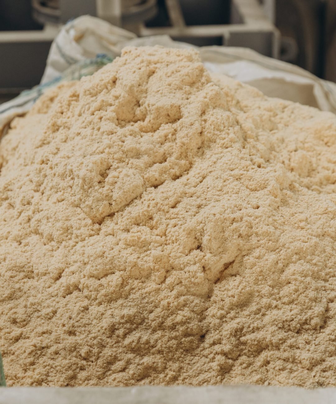 Close-up of a large bag brimming with sawdust, a key material in the modular building industry, highlighting sustainable construction practices
